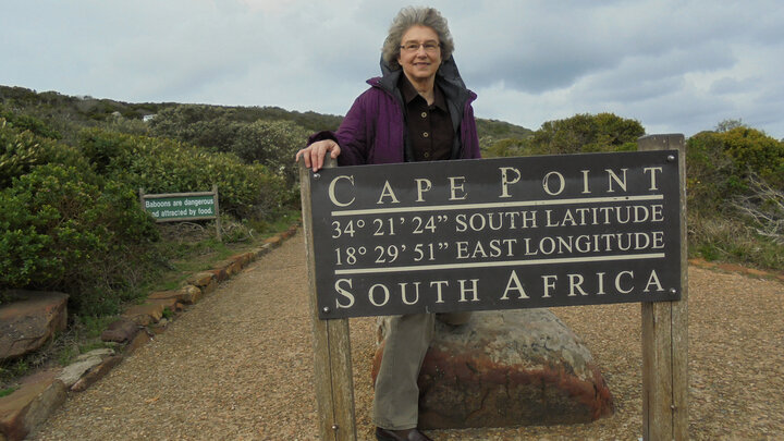 Nebraska's Sharon Hachtel stands by the Cape Point sign during a service trip to South Africa.